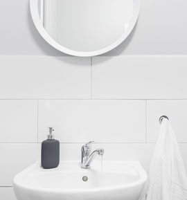Rundt hvitt speil i baderommet